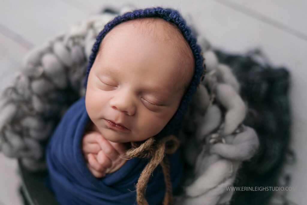Best Newborn Photographer in Kansas City. I see a slight smile here.